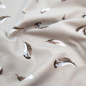 Preview: Kuschelweicher Jersey in hellem Nougat mit kleinen Federn gemustert