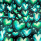 Preview: Kuschelweicher und warmer Sweatstoff in schwarz mit türkisfarbenen Herzen gemustert