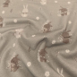 Preview: Kuschelweicher Jersey in taupe mit kleinen Winterhasen gemustert