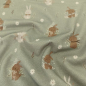 Preview: Kuschelweicher Jersey in altgrün mit kleinen Winterhasen gemustert