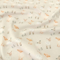 Preview: Kuschelweicher Jersey in hellem Sand mit Babyschafen gemustert
