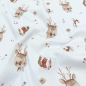 Preview: Weicher Ribjersey in offwhite mit süßen Rentierköpfen gemustert