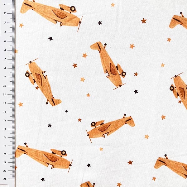 Preview: Baumwolljersey mit kleinen Flugzeugen in camel gemustert