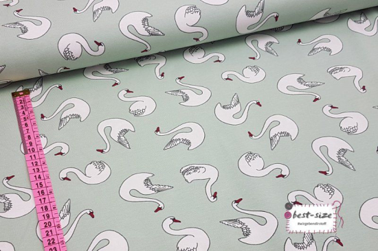 Preview: bio baumwolljersey in mintgruen mit weissen schwaenen mit massband links zur groesseneinordnung