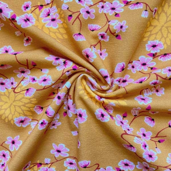 sehr weicher Baumwolljersey in senf mit Blümchen gemustert.