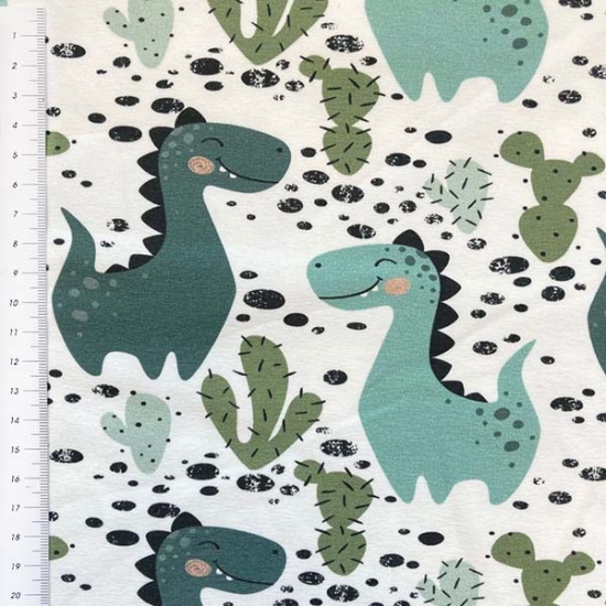 Preview: leicht angrauter French Terry in ecru mit Dinos gemustert.