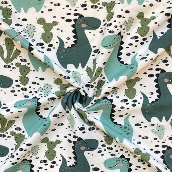 Preview: leicht angrauter French Terry in ecru mit Dinos gemustert.