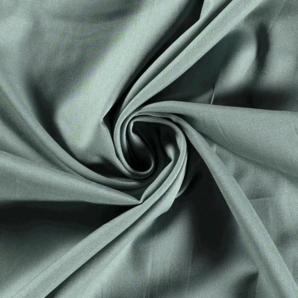 Baumwollstoff in Jade mit verschiedenen Mustern.