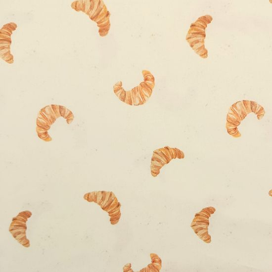 Weich fallender Baumwollstoff aus mit süßen Croissants gemustert