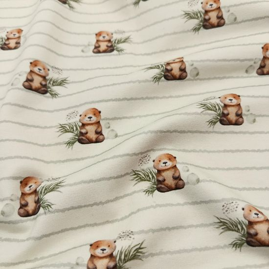 Weicher French Terry in ecru mit kleinen Ottern gemustert