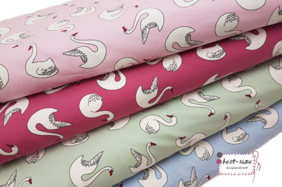 bio baumwolljersey mit motiven von weissen schwaenen in verschiedenen farben