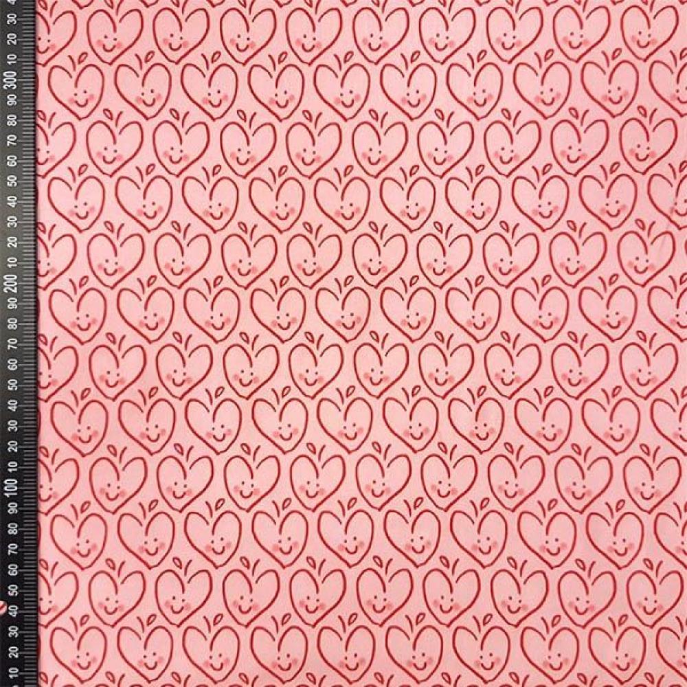 Baumwolljersey von HILCO rosa gemustert mit apfelmotiven in herzform und gesichtern im digitaldruck
