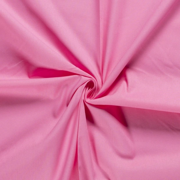 Baumwollstoff in rosa mit verschiedenen Mustern.