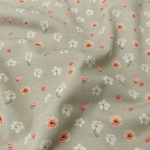 Kuschelweicher Jersey in taupe mit süßen Miniblüten und Herzchen gemustert