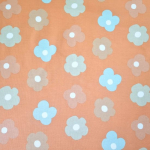 Weicher French Terry in melon mit Prilblumen in dezenten Farbtönen gemustert